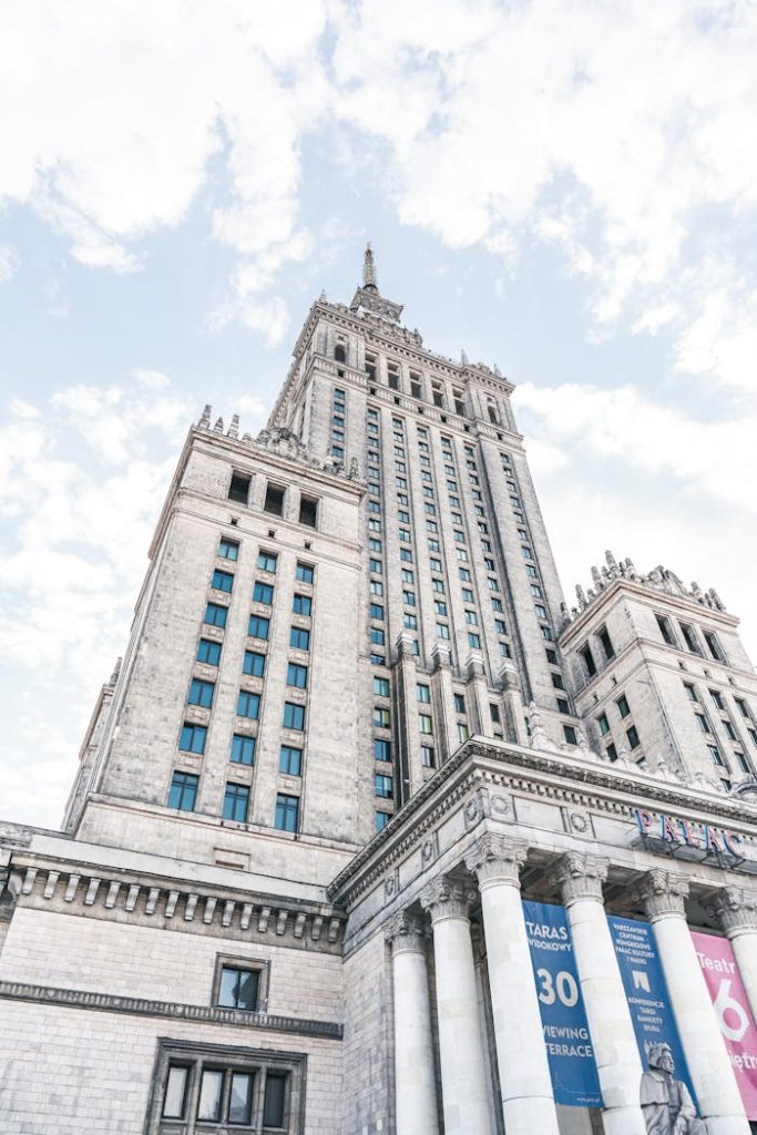 Impressive view of the iconic Palace of Culture and Science in Warsaw against a bright sky.