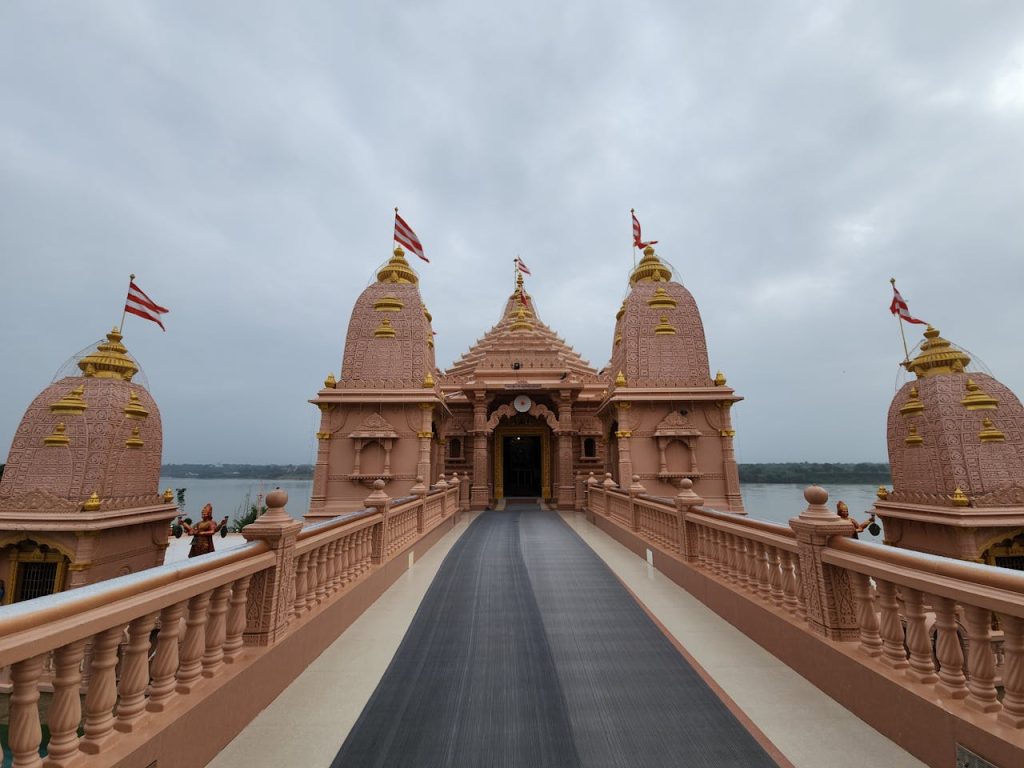 Beautiful temple with intricate architecture and flags on a cloudy day representing cultural heritage.